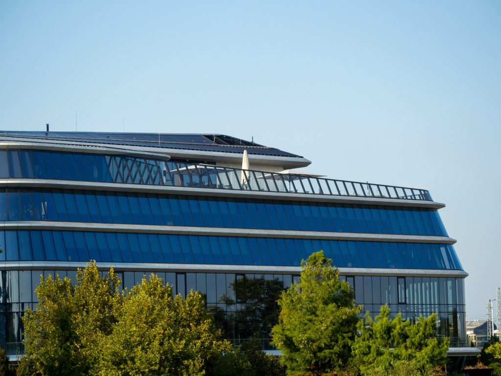 Modern glass building with solar panels on roof