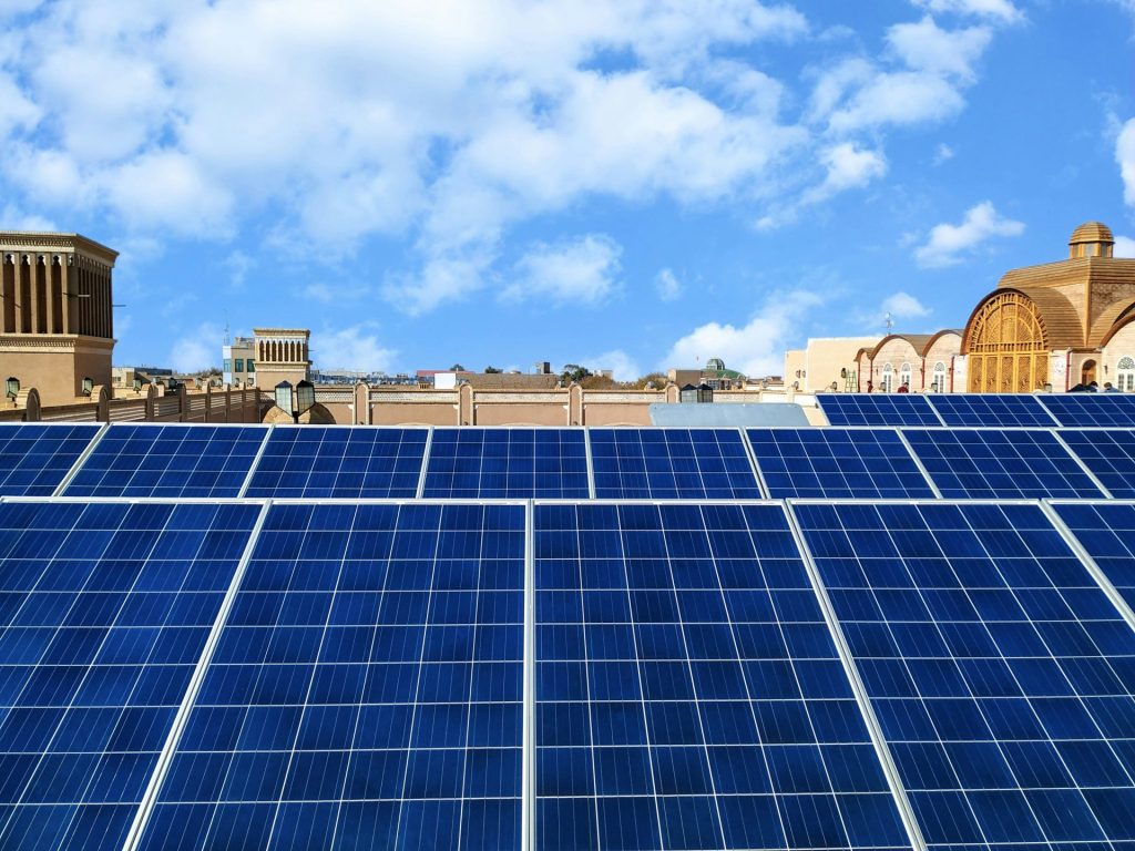 a row of solar panels on the roof of a building